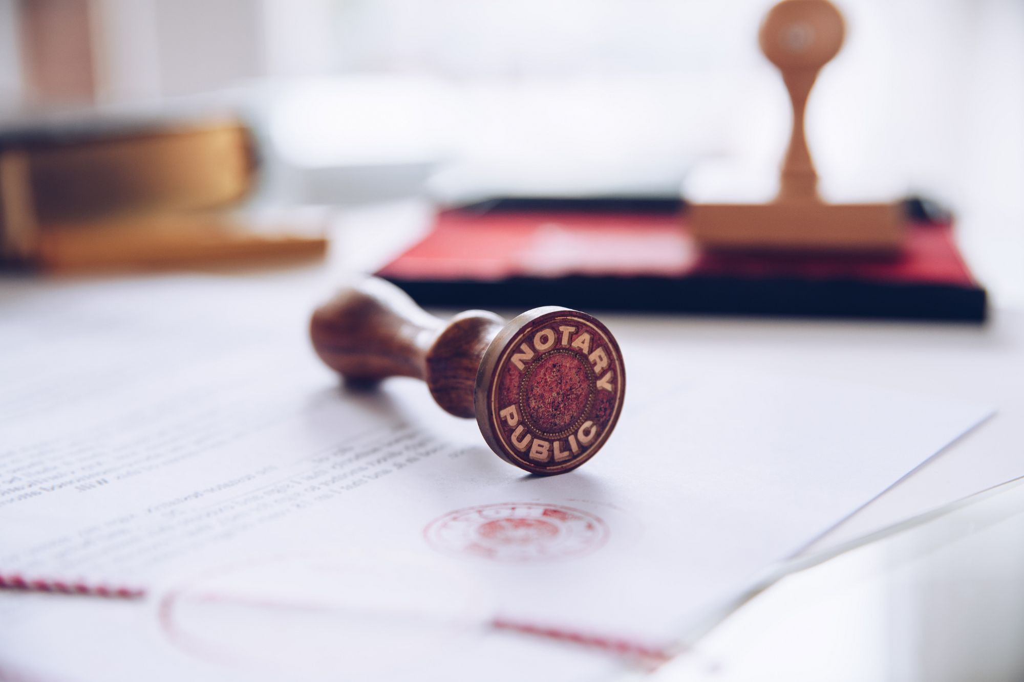 Close-up of a notary public stamp resting on a legal document, symbolizing official notarization services.