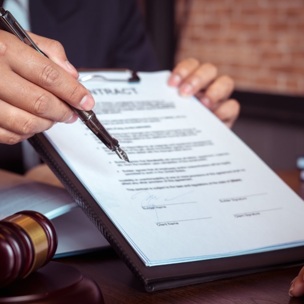 Notary Service (5) Professional notary explaining a legal contract to a client with a clipboard and pen, surrounded by legal symbols like a gavel and scale of justice.